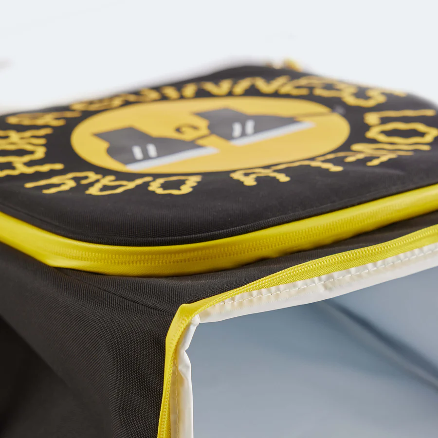 The Guinness x Fatti Burke Sun Cooler Bag by Guinness Webstore UK is a black insulated backpack with yellow trim, mesh side pocket, and two padded shoulder straps—ideal for keeping drinks cool on any island adventure.